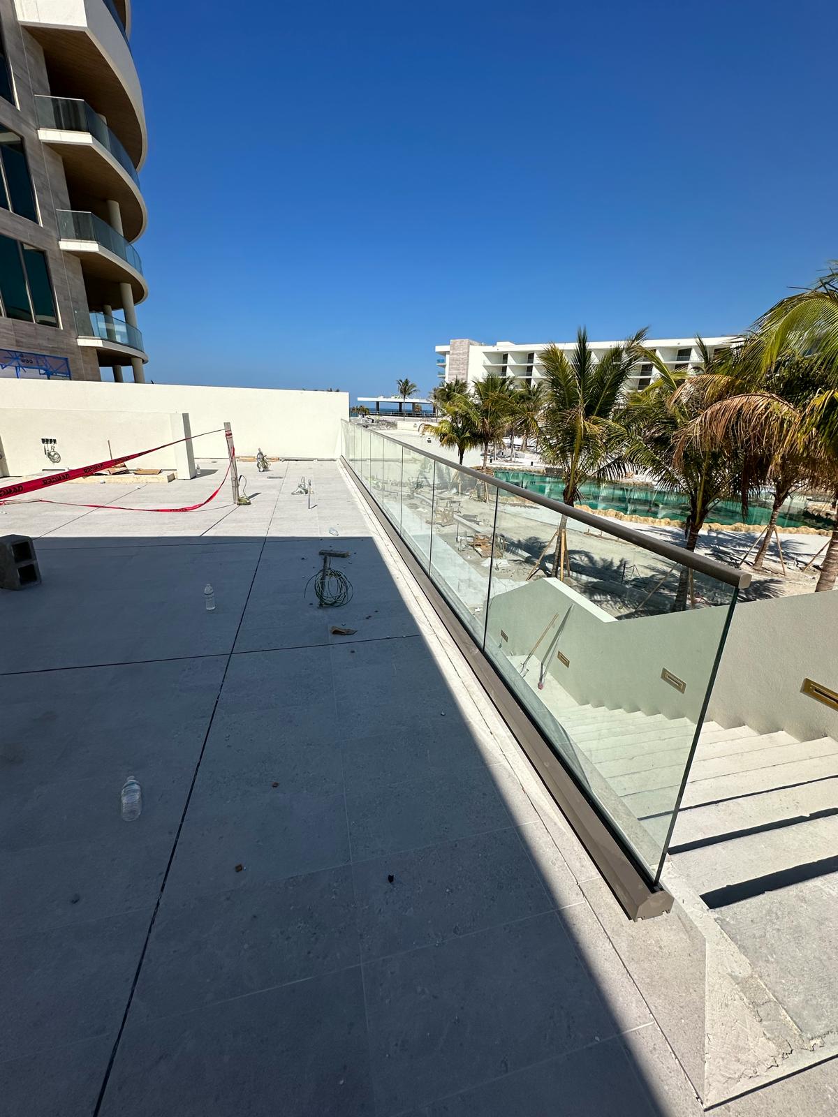 Infinity glass railing overlooking the St. Regis Resort grounds